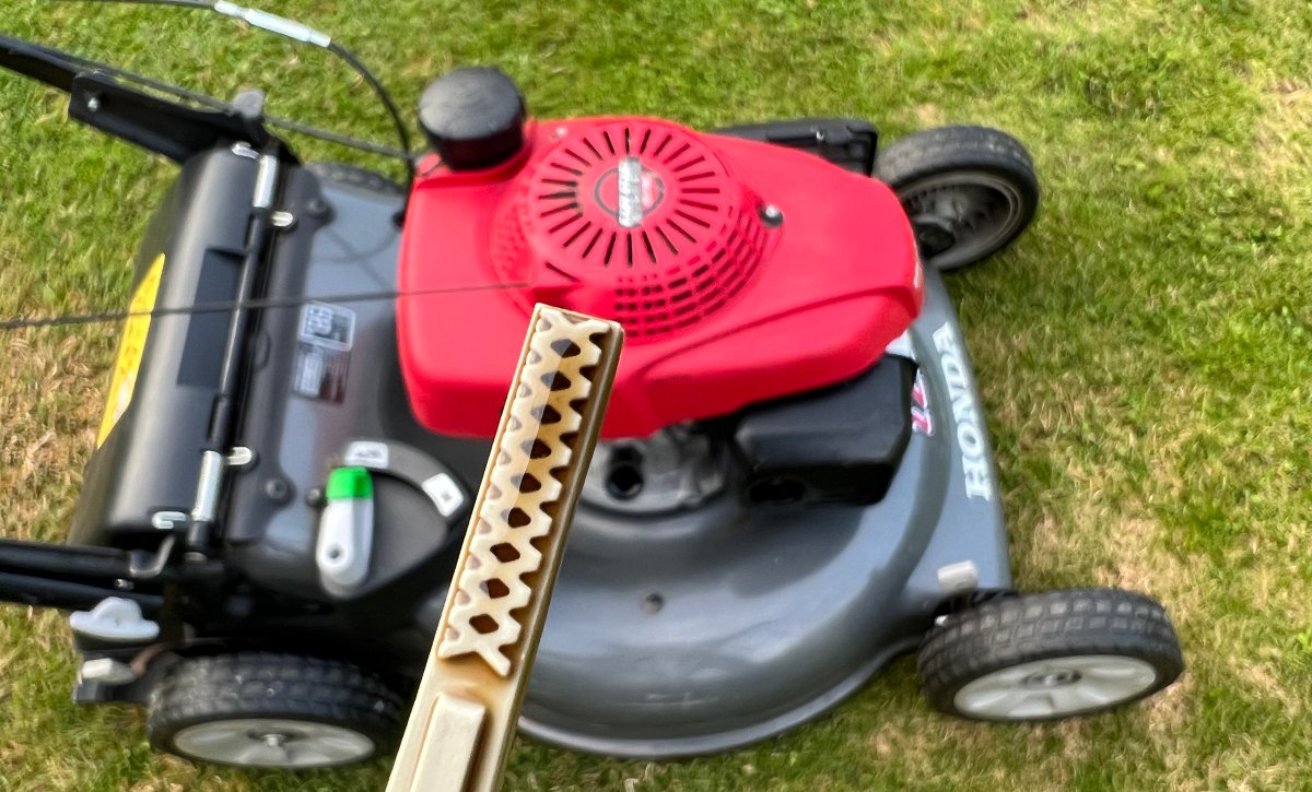checking oil level in lawn mower using dipstick