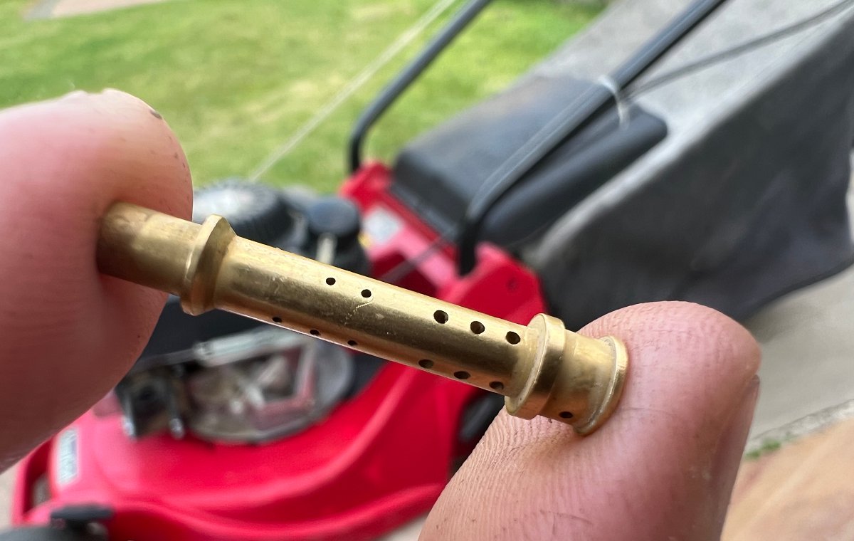 tiny holes on the jets from the inside of a lawn mower carburetor