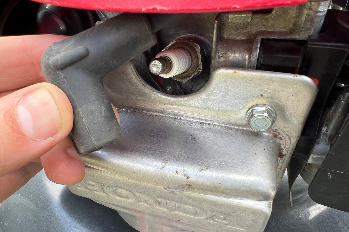 disconnect lawn mower spark plug boot to prevent accidental start up