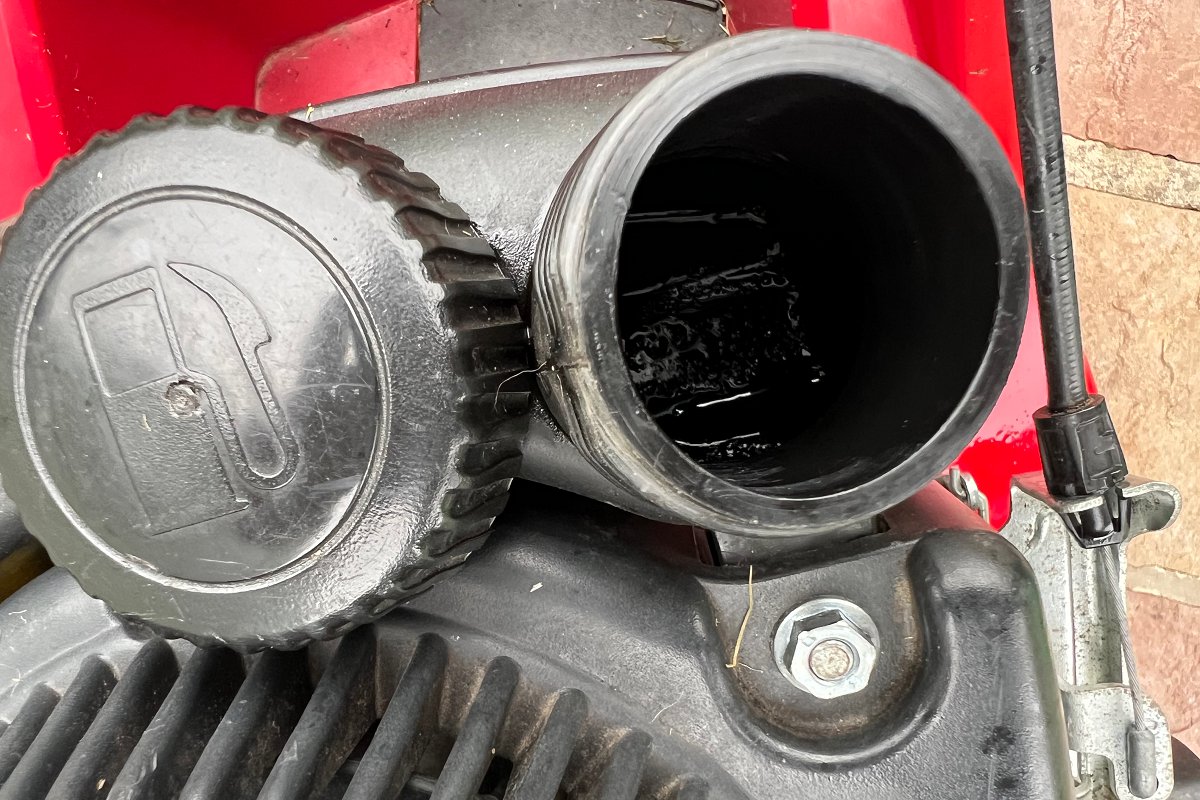 checking gas tank and finding mower has no gas and could be vapor-locked